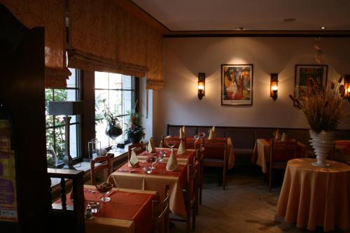 a dining room with tables and chairs in a restaurant at Le Pavillon in Echternach