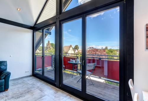 a room with sliding glass doors leading to a balcony at Ferienwohnung Carlotta in Trassenheide