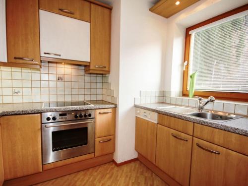 a kitchen with a sink and a stove at Apartment Schwarzwald 6 EG by Interhome in Radenthein