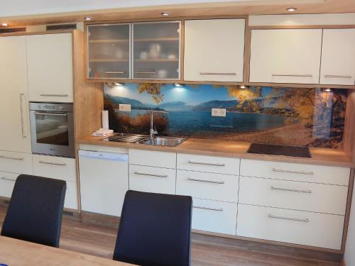 een keuken met witte kasten en een spoelbak bij Studio Rupertus-5 by Interhome in Maishofen