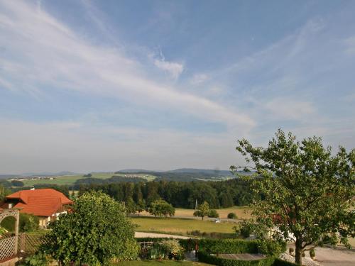 a view of a field with a house and a tree at Apartment Eisele by Interhome in Kirchberg bei Mattighofen