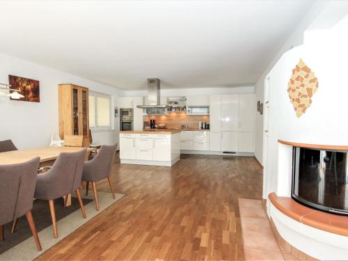 a kitchen and dining room with a table and chairs at Holiday Home Linnehan by Interhome in Fügen