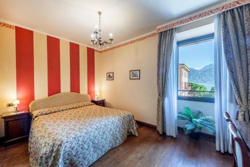 a bedroom with a bed and a large window at La Dependance in Menaggio