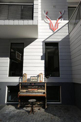 a piano sitting outside of a building with a sign on it at Borjomi UnderWood in Borjomi