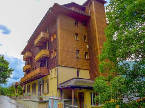 a tall building with balconies on the side of it at Apartment Schweizerhof Apt- B by Interhome in Wengen