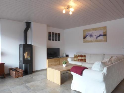 a living room with a couch and a wood stove at Apartment Am Acher II by Interhome in Wengen