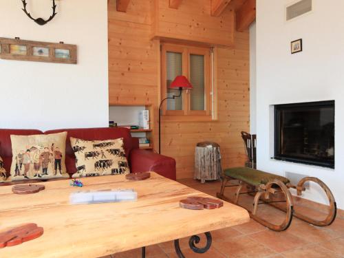 a living room with a wooden table and a couch at Apartment Fénestral 301 by Interhome in Ovronnaz