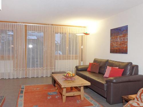 a living room with a couch and a coffee table at Apartment Schoneggacher Apt- S by Interhome in Wengen