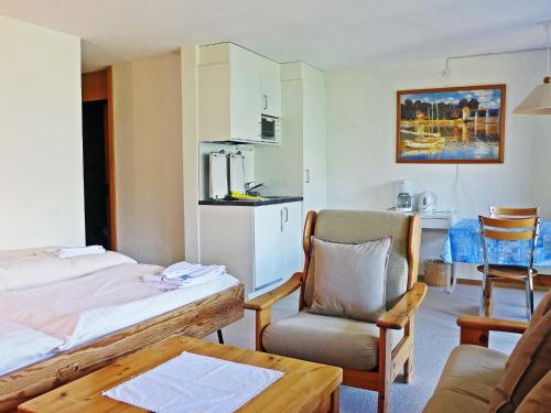 ヴェンゲンにあるApartment Primula by Interhomeのベッド1台、椅子、テーブルが備わる客室です。