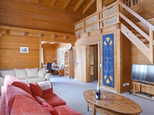 a living room with a couch and a tv at Chalet Arche by Interhome in Wengen