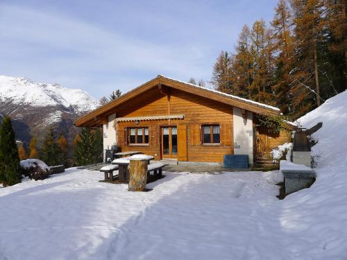 a log cabin in the snow with a table in front at Chalet Als man zählte 1989 by Interhome in Gasenried