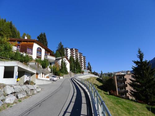 a street with a fence on the side of a road at Apartment Guardaval - Utoring-44 by Interhome in Davos