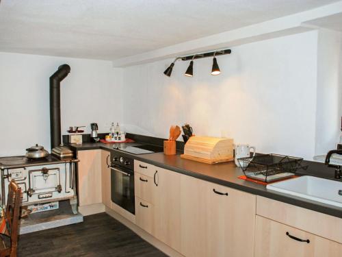 a kitchen with a stove and a counter top at Apartment Peppa by Interhome in Chironico