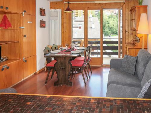 a living room with a table with chairs and a couch at Apartment Beau-Séjour 24 by Interhome in Nendaz