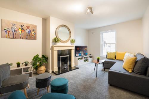 a living room with a couch and a fireplace at Escape Ordinary at Devenish Manor in Enniskillen