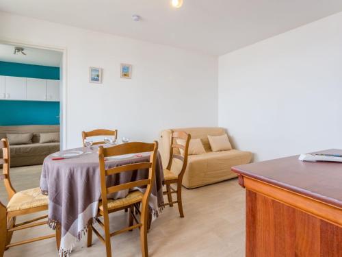 un salon avec une table, des chaises et un canapé dans l'établissement Apartment les Colombières-9 by Interhome, à Villers-sur-Mer