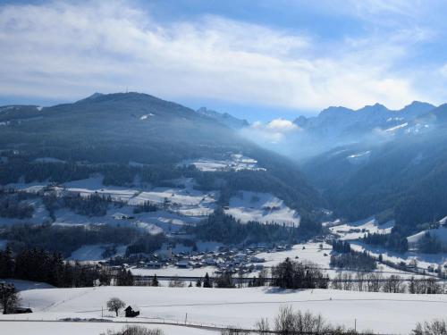 a snow covered valley with a town and mountains at Apartment Poldi by Interhome in Haus im Ennstal
