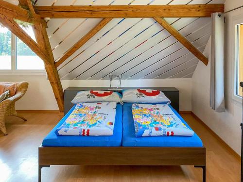 two beds in a room with a attic at Studio Arn's Dachstudio by Interhome in Wangenried  