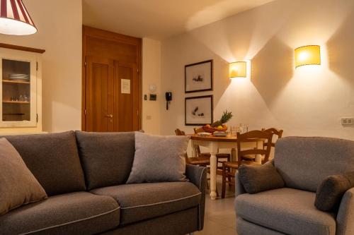 a living room with a couch and a table at Roccamare Resort - Ville e Appartamenti in Castiglione della Pescaia