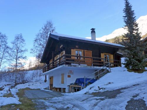 a house on top of a snow covered mountain at Chalet Coquelicot by Interhome in Zinal