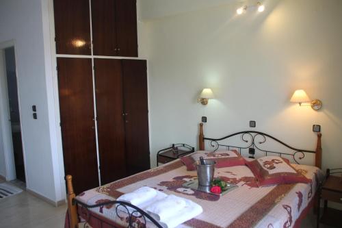 a bedroom with a bed with a table and towels at Panorama in Agios Georgios