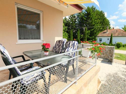 a balcony with chairs and a table on a house at Apartment Beige by Interhome in Balatonszemes