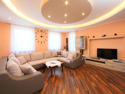 a living room with a couch and a tv at Apartment Beige by Interhome in Balatonszemes