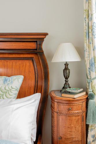 a bedroom with a bed and a lamp on a night stand at Screebe House in Rosmuck