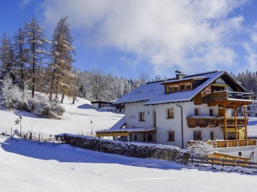 a large house in the snow with snow at Apartment Renauer by Interhome in Mösern