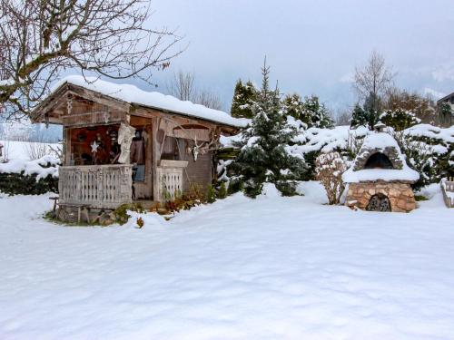 an out house in the snow with a fireplace at Apartment Tyrol-2 by Interhome in Aschau