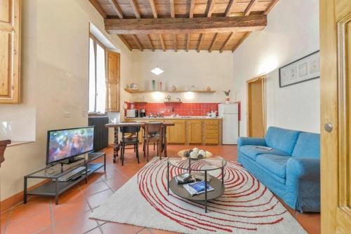 
a living room filled with furniture and a tv at Giglio in Florence
