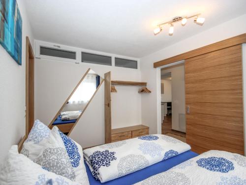 a bedroom with two beds and a closet at Apartment IsiLiving by Interhome in Fliess