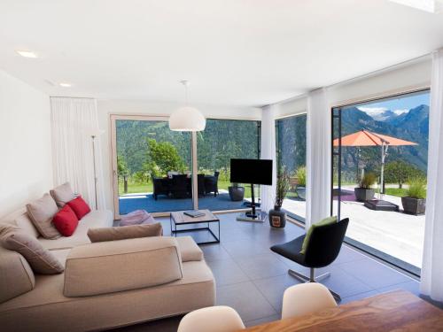 a living room with a couch and a television at Apartment Zenkei by Interhome in Leontica