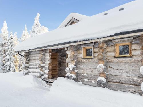 a log cabin in the snow at Holiday Home Kelovalta 7b by Interhome in Ruka