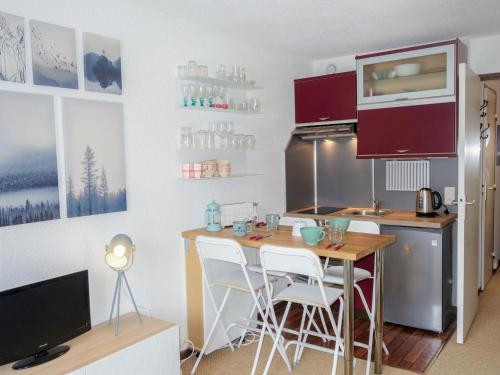 a kitchen with a table and chairs in a room at Studio Le Sapin-1 by Interhome in Demi-Quartier
