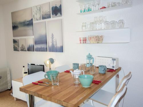 a dining room table with blue dishes on it at Studio Le Sapin-1 by Interhome in Demi-Quartier