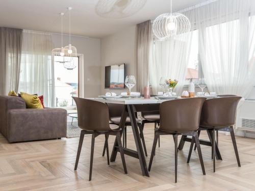 a dining room with a table and chairs at Apartment Villa Malu Sun I by Interhome in Brodarica