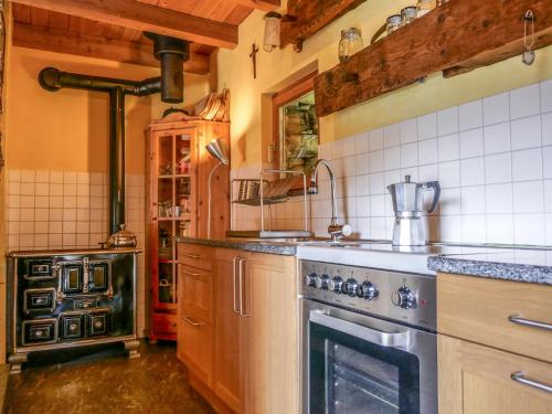 a kitchen with a stove and an oven at Holiday Home Rustico Cà dru Lurenz by Interhome in Malvaglia