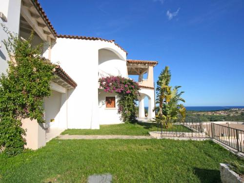 a white house with a view of the ocean at Apartment Panorama 5 by Interhome in Tanaunella