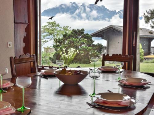 a table with glasses and a bowl of fruit on it at Villa Duck House by Interhome in Clarens