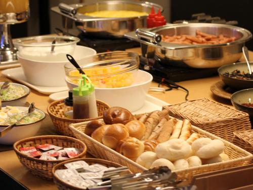 a table with many baskets of food on it at Meitetsu Inn Chita Handa Ekimae in Handa