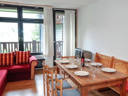 a living room with a wooden table and a couch at Apartment Taubenschlag - Top 4 by Interhome in Grünau im Almtal