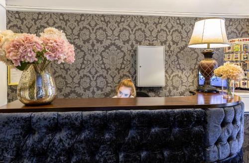 two women sitting at a table in front of a mirror at Clifden House by Nina in Dublin