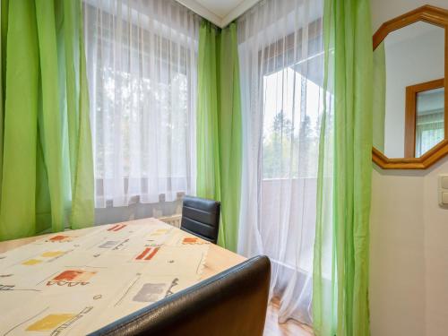 a room with a table and a window with green curtains at Apartment Kleinsee by Interhome in Srejach