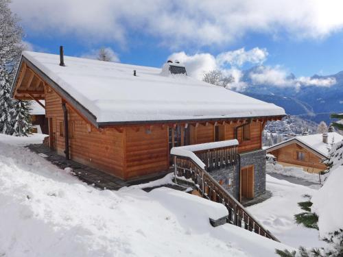 a log cabin with snow on the roof at Chalet Chalet Maurice by Interhome in Chesières