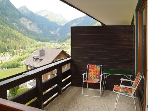 a balcony with two chairs and a table and a view at Studio Top 46 A by Interhome in Heiligenblut