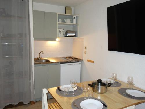 a kitchen with a table with two plates on it at Apartment La Piste-3 by Interhome in Saint-Gervais-les-Bains