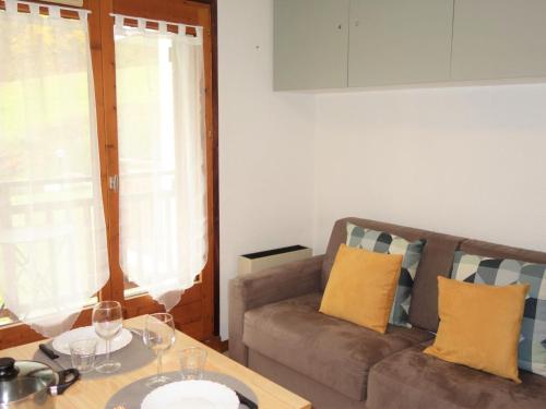 a living room with a couch and a table at Apartment La piste A by Interhome in Saint-Gervais-les-Bains