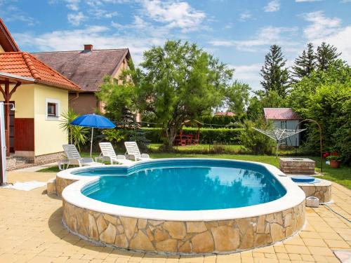 a swimming pool with a stone wall around it at Holiday Home Yellow 2 by Interhome in Balatonmáriafürdő