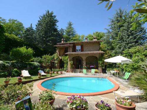 a swimming pool in front of a house at Villa La Goccia by Interhome in Piegaro